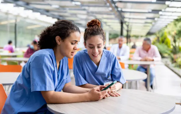 Trainees checking certifications on phone